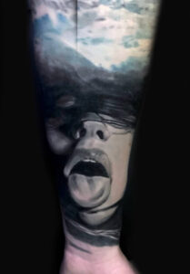Tattoo Anansi Studio München Munich Haidhausen Peter forearm tongue out girl blinded dark best black and grey realistic realism